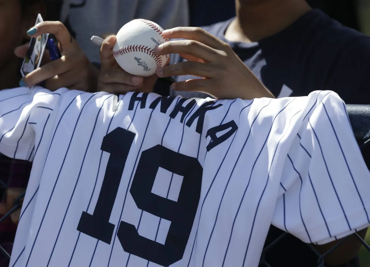 Man holding a New York Yankees ujersey